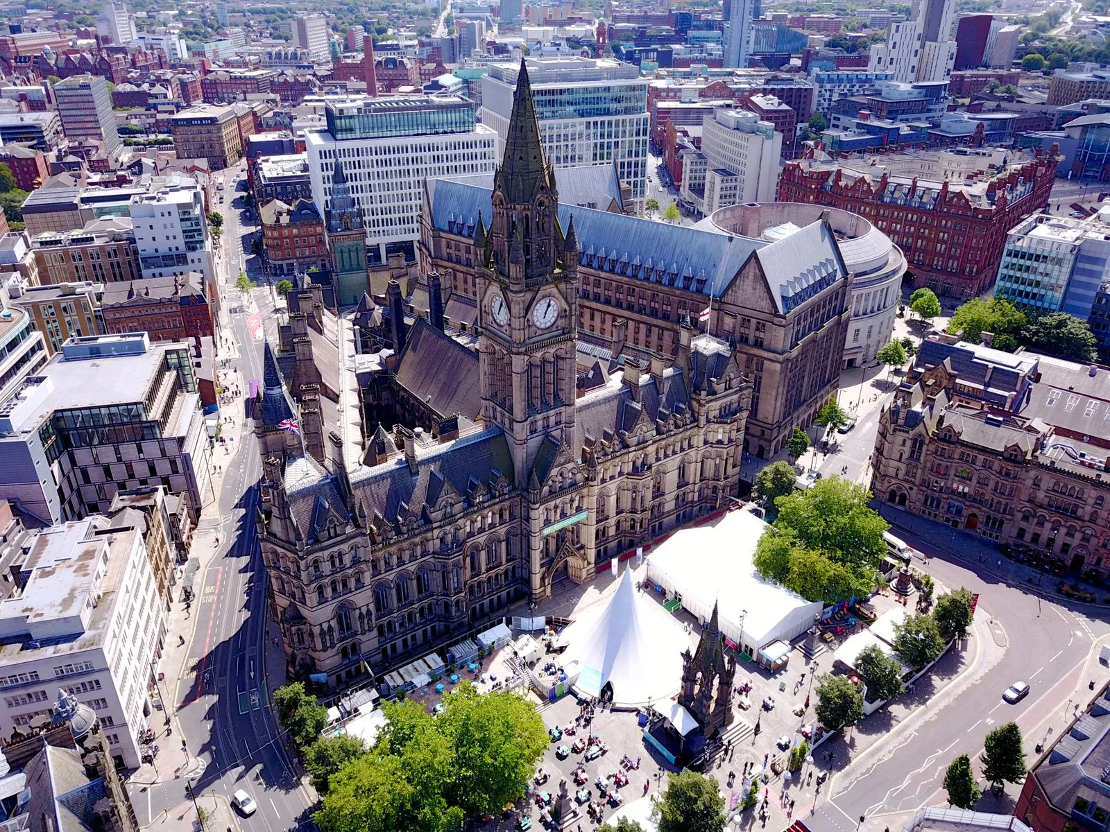 Aerial view of the iconic Manchester Town Hall and surrounding cityscape in the United Kingdom.